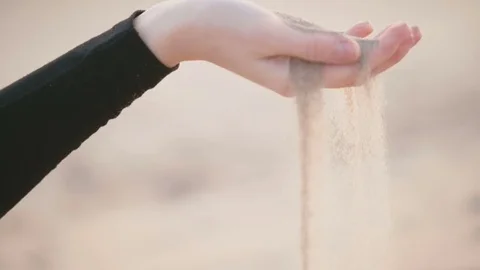 Sand falls from the woman's palm Stock Footage 77410047