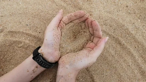 Sand falls women hands Stock Footage