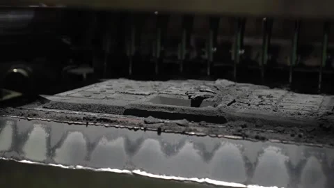 Sand filling and compacting machine depositing black molding sand into casting Stock Footage 336681723