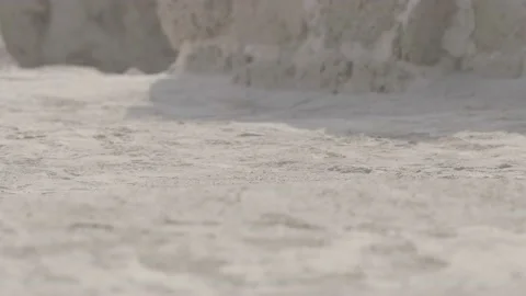 Sand flies in slow motion over rocky ground in a Middle Eastern ruin Stock Footage 135453004
