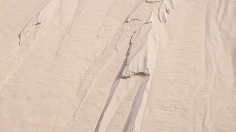 Sand flowing down the side of light dune Stock-Footage 76936239