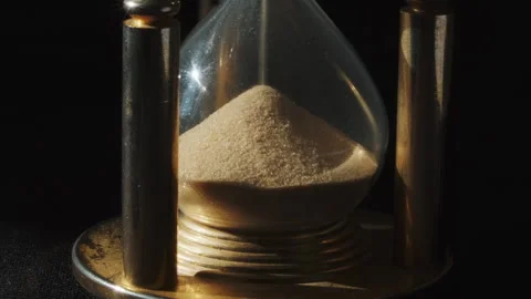 Sand flowing past through an hourglass Stock Footage 337640472