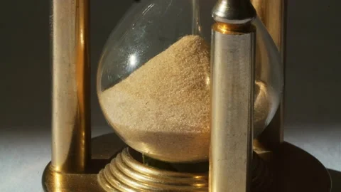 Sand flowing past through an hourglass Stock Footage 337679873