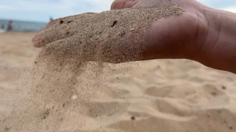 Sand flowing from a woman's hand Stock Footage 313428010
