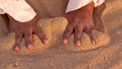 Sand flows away Pouring leaking  from through hands fingers Video stock 96726636