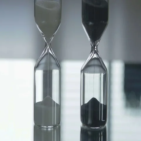 Sand flows through a hourglass Stock Footage 69487466