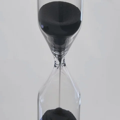 Sand flows through a hourglass Stock Footage 69487778