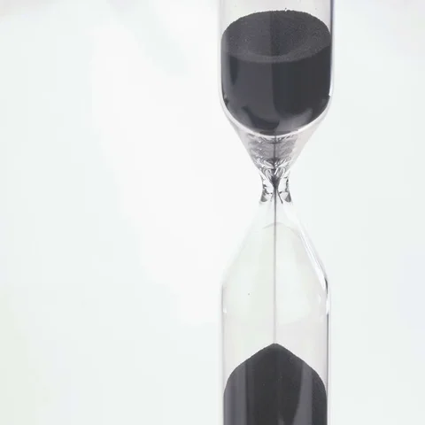 Sand flows through a hourglass Stock Footage 69487796