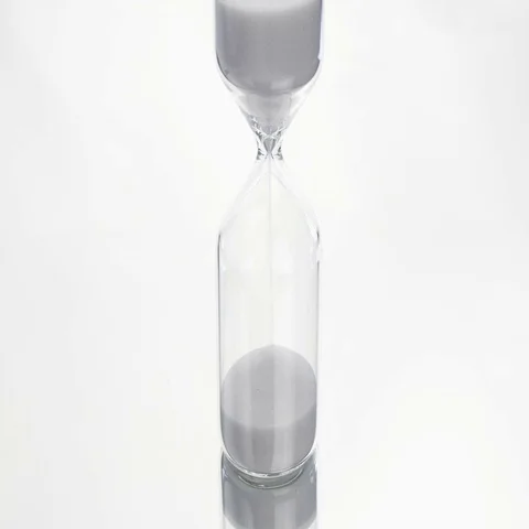 Sand flows through a hourglass Stock Footage 69487797