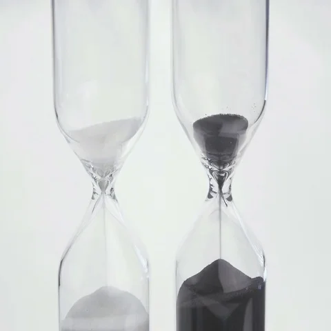 Sand flows through a hourglass Stock Footage 69487821
