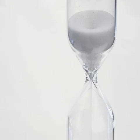 Sand flows through a hourglass Stock Footage 69487873