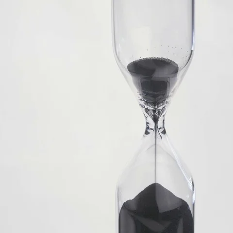 Sand flows through a hourglass Stock Footage 69487886