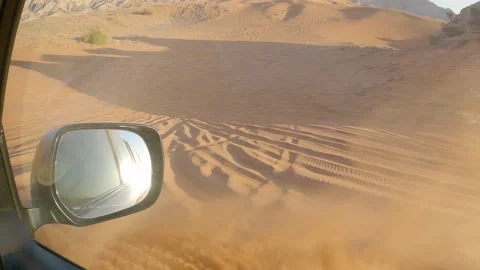 Sand flying from SUV wheel during fast desert ride, off road action Stock Footage 329119687