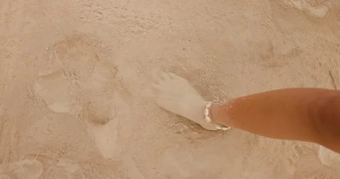 Sand foot stomp at NS beach captures playful moment in the sun with light waves Stock Footage 318369145