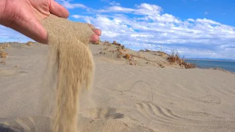 Sand in hands of desert concept Stock Photos