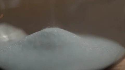 Sand of an Hourglass Trickling Down Closeup Stock Footage 99164944