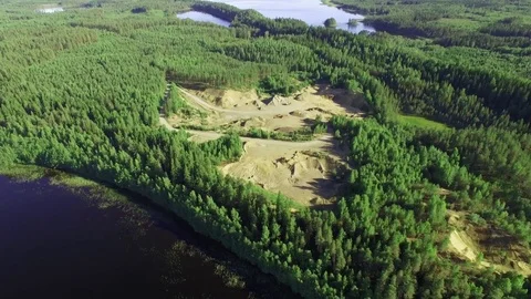 Sand mine in forest between lakes. Aerial shot. Stock Footage 84636667