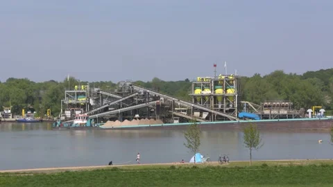 Sand mining along the river Rhine. Recreation area + dog walker in front Stock Footage 134036453