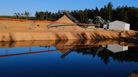 Sand mining. Equipment for sand extraction on the shore of the pond Stock Footage 266567785