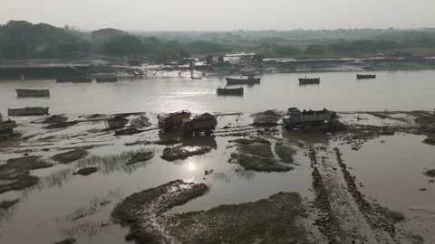Sand mining at river bank and trucks are loaded with the black send. Stock Footage 254489049