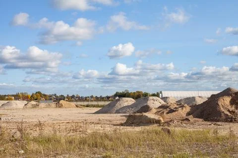 Sand mountains at the construction site. Stock Photos