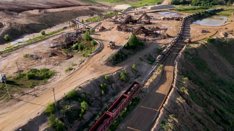 Sand open pit. Wheel loader loading rocks in freight train. 스톡 동영상 156598981