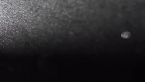 Sand particles floating in a beam of light Stock Footage 79786618