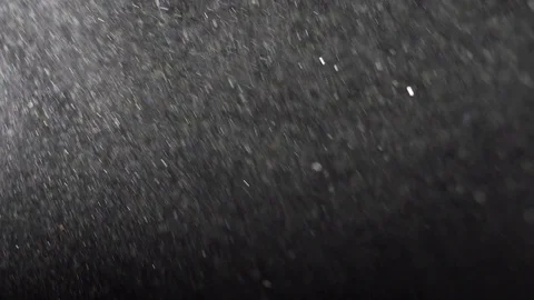 Sand particles floating in a beam of light Stock Footage 79786684