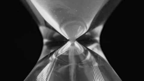 Sand particles of hourglass fall through bottle-neck, pressure concept Stock Footage 296796060