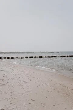 Sand path to the sea. Beach with view on calm sea Stock Photos