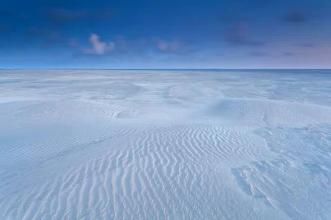 Sand pattern on beach at sunrise Stock Photos