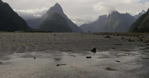 Sand patterns and tide pools in Milford Sound New Zealand Video stock 120496570