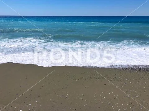 Sand, pebbles and the sea. Stock Photos