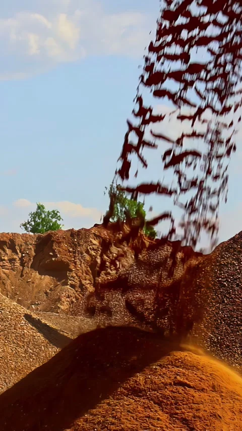 Sand Pouring Off An Elevated Conveyor Onto A Large Pile - Vertical Shot Stock Footage 315264778