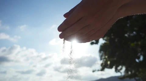Sand Pours from Hands on a Glare of the Sun. Slow Motion Stock Footage 59149275