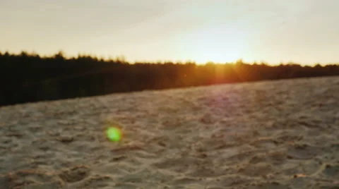 Sand pours from the man's hands at sunset. Concept: the transience of time Stock Footage 66146986