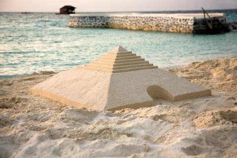 Sand pyramid on the beach Stock Photos