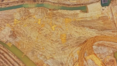Sand quarry with distinct patterns from machinery movement and water Stock Footage 337391769