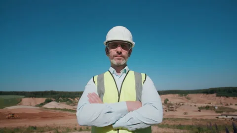 Sand quarry engineer crossing arms looking at camera. Mining project specialist Stock Footage 155944858