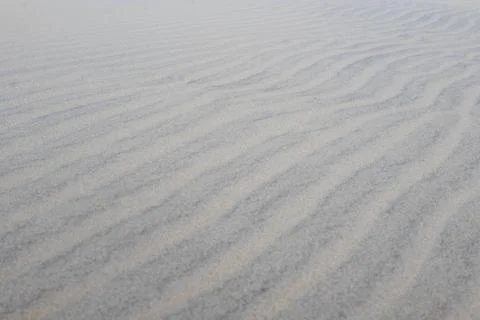 Sand ripple pattern and waves Stock Photos