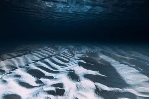 Sand ripples on ocean floor create a serene and abstract underwater seascape Stock Photos