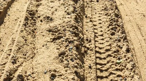 Sand road surface texture with tire tracks close-up Stock Photos