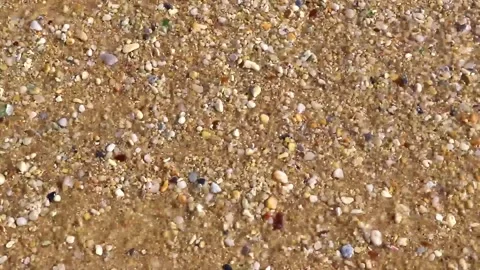 Sand rocks pebbles mussels shells waves Kalim Beach Phuket Thailand. 動画素材 322720460