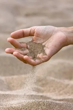 Sand running through hand Stock Photos