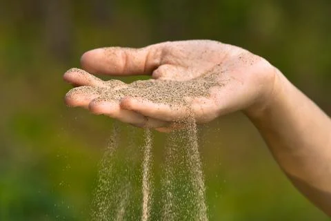 Sand running through hand like time running out Stock Photos