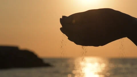 Sand running through a woman's hands. Stock Footage 90779399