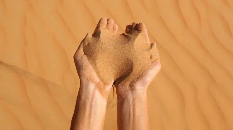 Sand running trough fingers top view Stock Footage