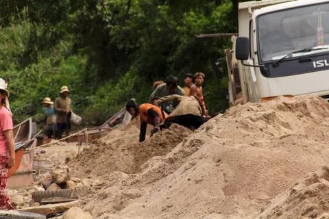 Sand scooping career Sand is a component in construction Stock Photos