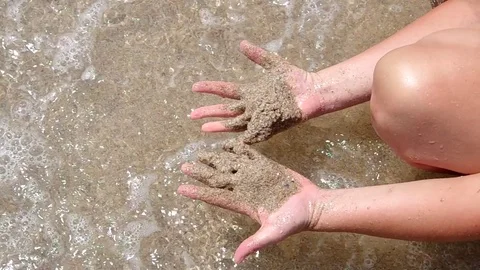 Sand in the sea on their hands Stock Footage 73336984