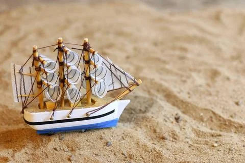 Sand shell and sail in sea seashells and sand on blue sky background conce... Stock-Fotos
